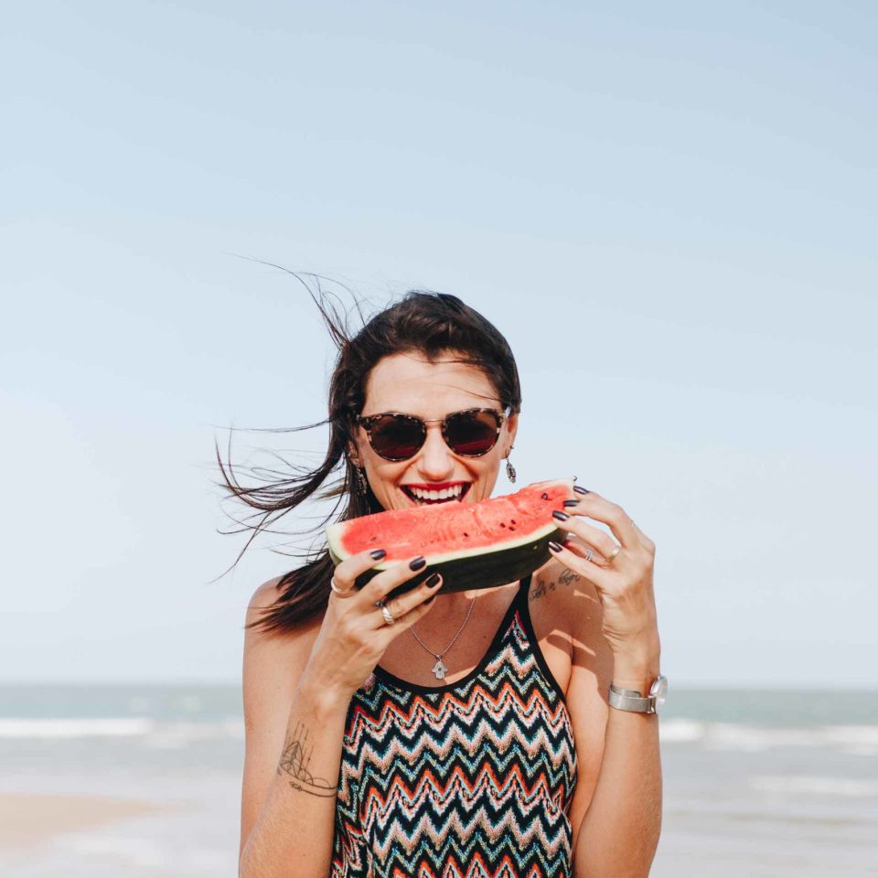 woman-eating-watermelon-at-the-beach-R2E5TKF-scaled.jpg